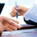 profissional lendo e assinando contrato de prestacao de servicos com seguranca juridica